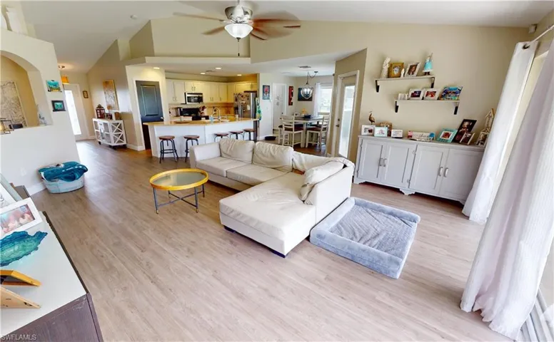 Living room featuring ceiling fan and light wood-type flooring
