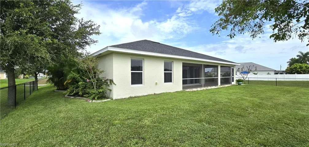 Rear view of house featuring a yard