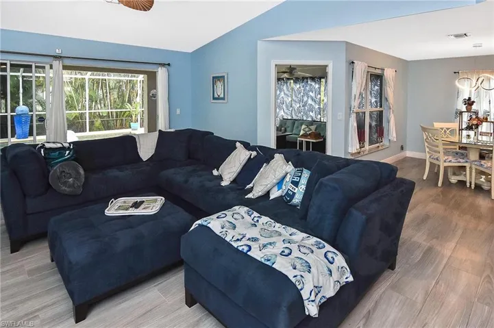 Living room featuring hardwood / wood-style flooring and vaulted ceiling