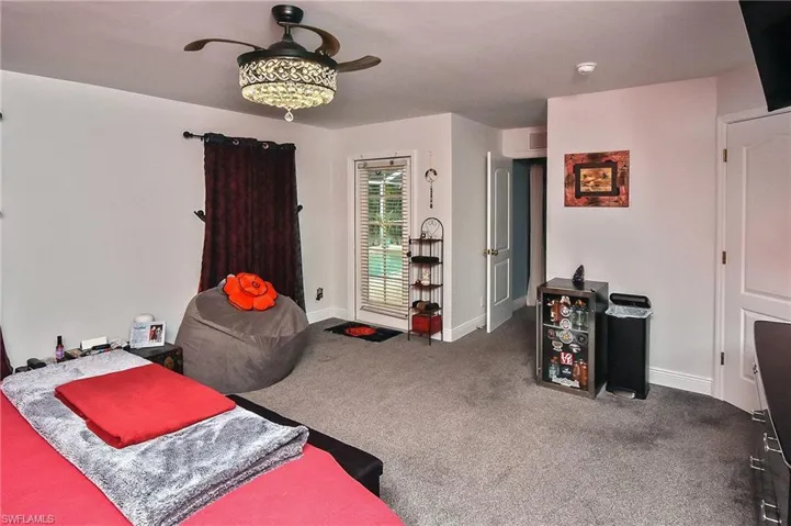 Carpeted bedroom with ceiling fan