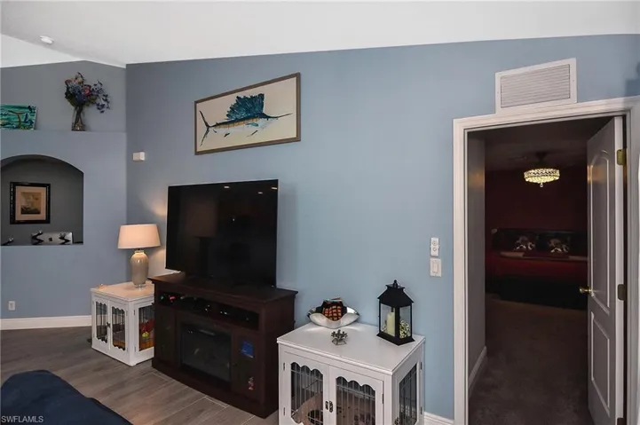 Living room with tile flooring and lofted ceiling