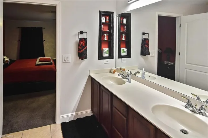 Bathroom featuring tile patterned floors and double sink vanity