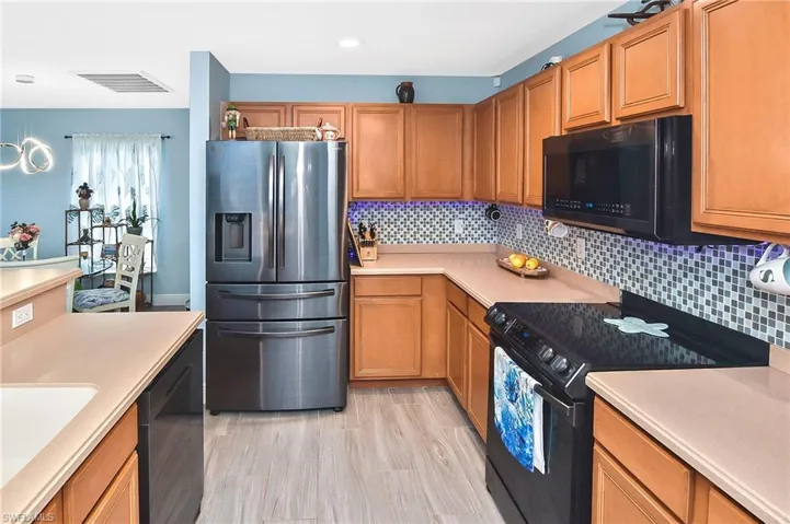 Kitchen featuring sink, stainless steel appliances, and tasteful backsplash