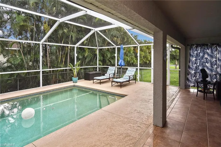 View of pool with a patio and a lanai