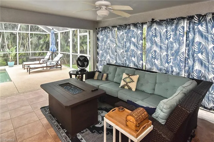 Sunroom featuring ceiling fan