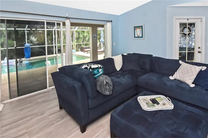 Living room featuring lofted ceiling and wood-type flooring