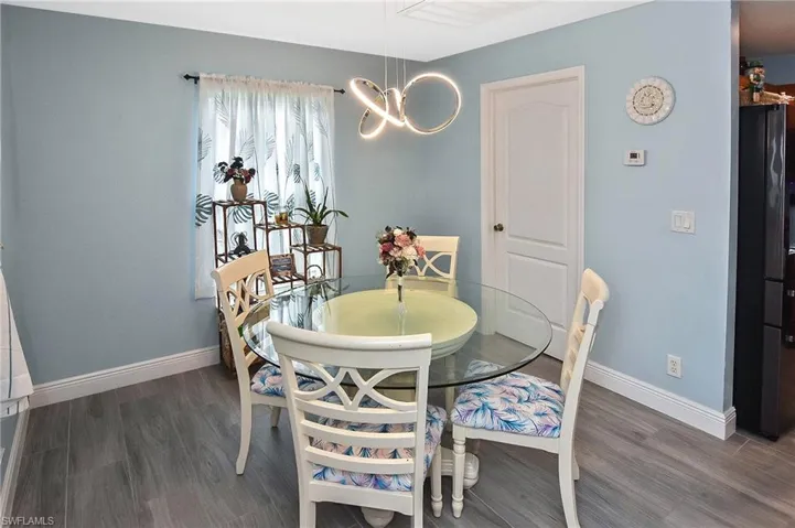 Dining room featuring a chandelier and dark hardwood / wood-style flooring