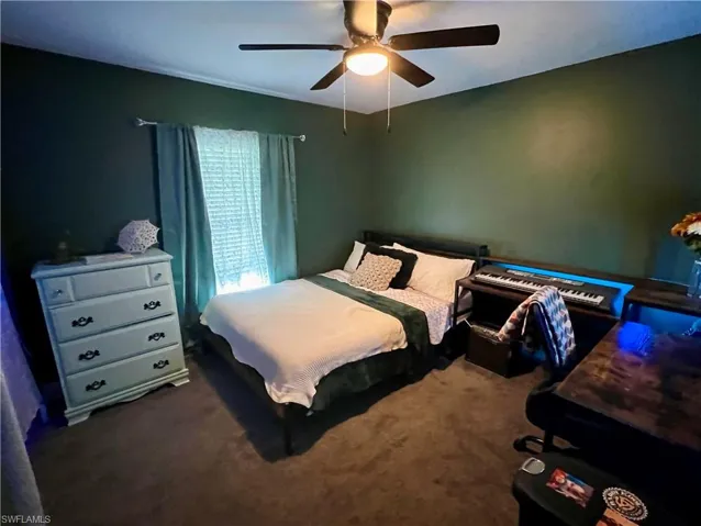 Carpeted bedroom with ceiling fan