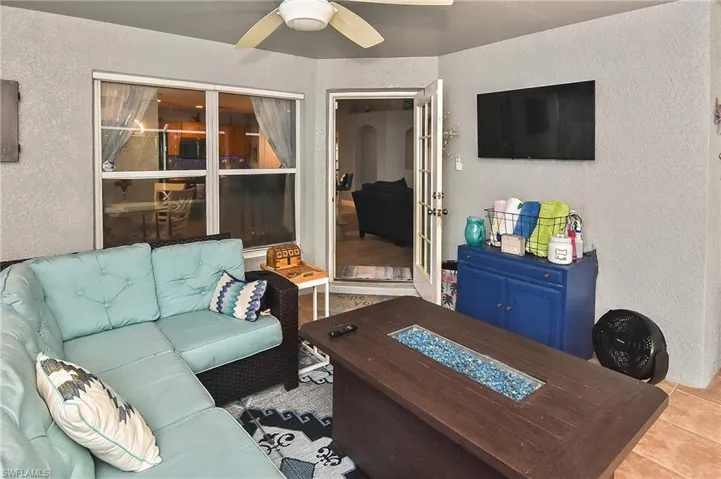 Tiled living room featuring ceiling fan