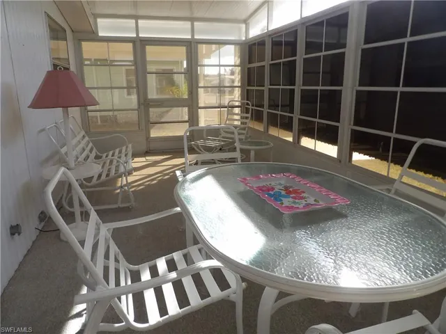 Sunroom featuring plenty of natural light and outdoor dining space