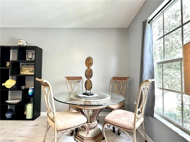 Dining area with plenty of natural light and hardwood / wood-style flooring