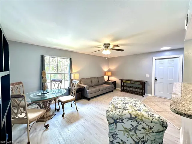 Living room with ceiling fan and light wood-type flooring