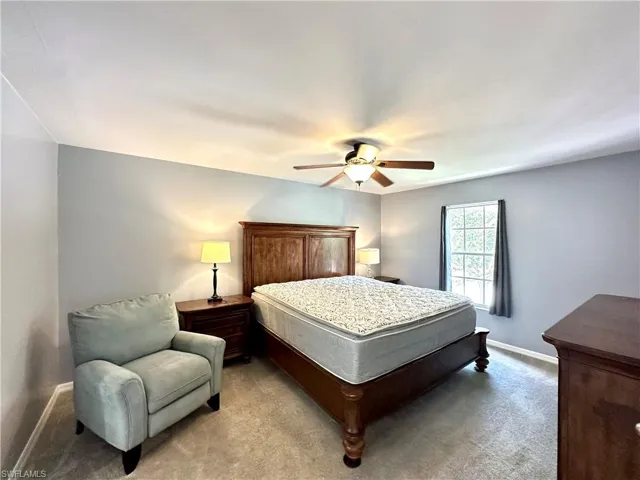 Bedroom featuring light carpet and ceiling fan