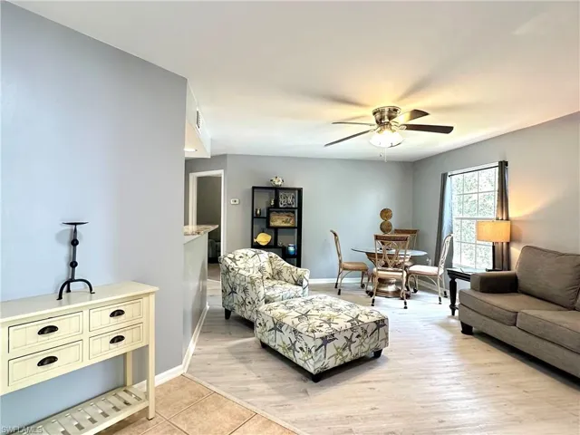 Living room featuring light hardwood / wood-style flooring and ceiling fan