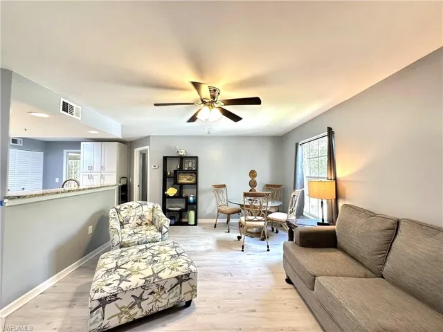 Living room featuring light hardwood / wood-style flooring and ceiling fan