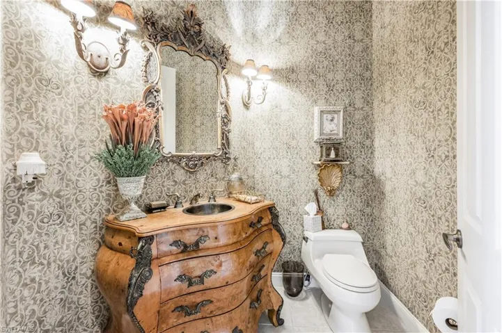 Bathroom featuring tile patterned flooring, toilet, and vanity