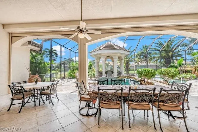 View of patio with glass enclosure and ceiling fan