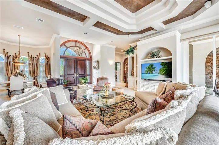 Living room featuring hardwood / wood-style flooring and crown molding