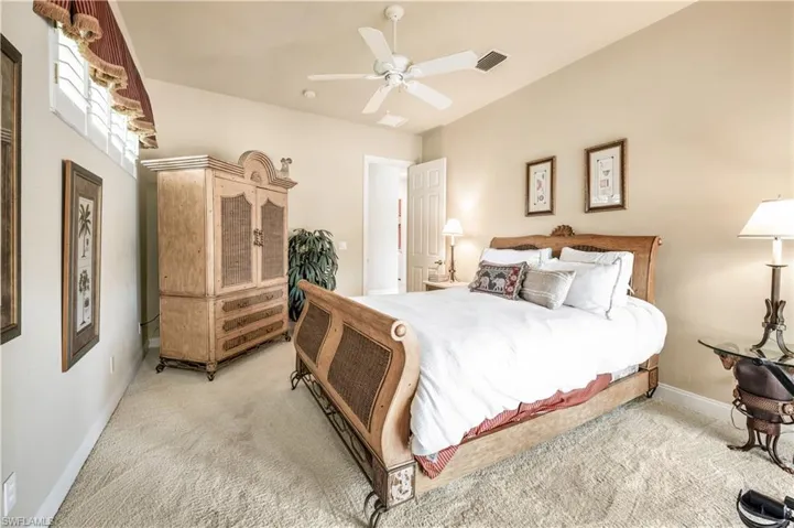 Carpeted bedroom featuring ceiling fan