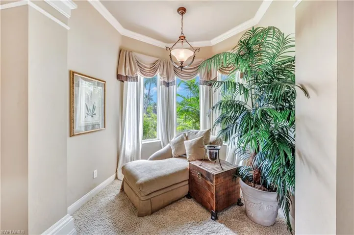 Sitting room featuring crown molding and carpet flooring