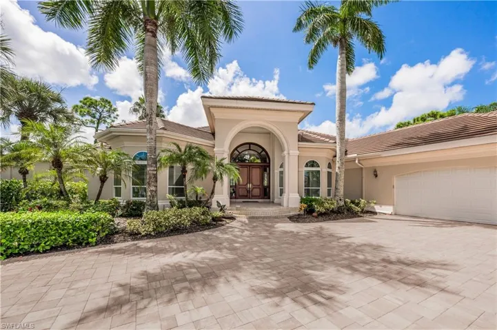 Mediterranean / spanish-style home with a garage