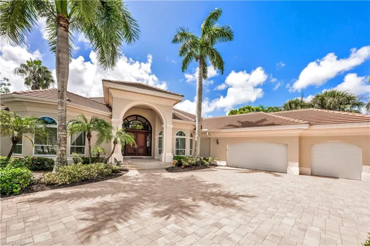 Mediterranean / spanish-style home with a garage