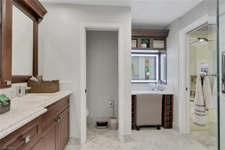 Full bathroom with vanity and ceiling fan