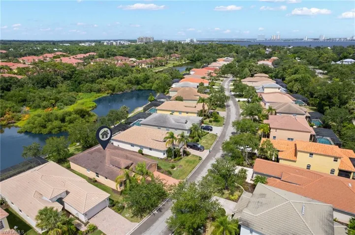 Aerial perspective showcasing a residential community with water frontage