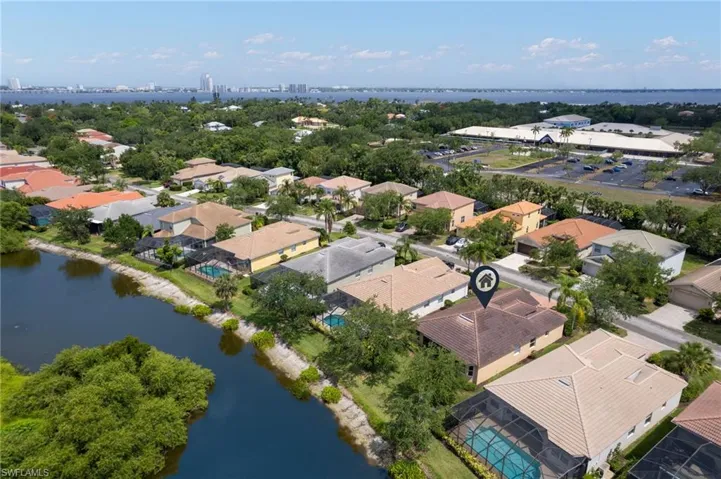 Aerial perspective showcasing residential properties with terracotta tile roofing and screened swimming pools