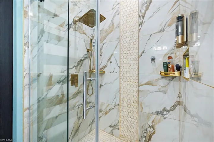 Full bathroom featuring a marble finish shower