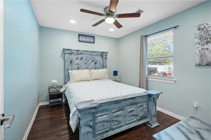 Bedroom with baseboards, dark wood-style flooring, ceiling fan, and recessed lighting