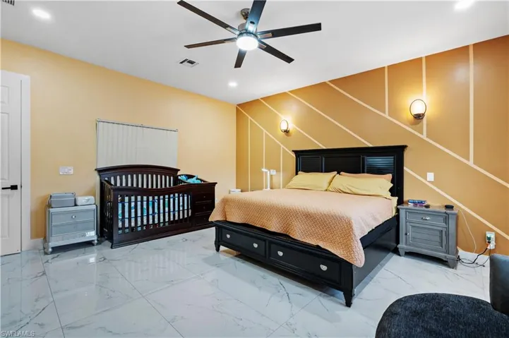 Bedroom featuring marble finish flooring, recessed lighting, and a ceiling fan
