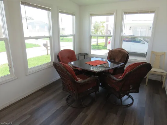 Dining area with wood finished floors and healthy amount of natural light