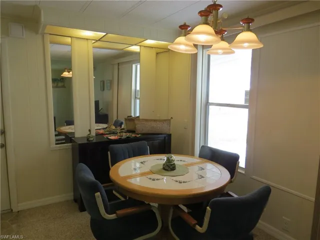 Dining area featuring plenty of natural light and a decorative wall
