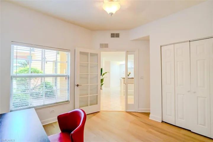 Office space featuring light wood-type flooring and french doors