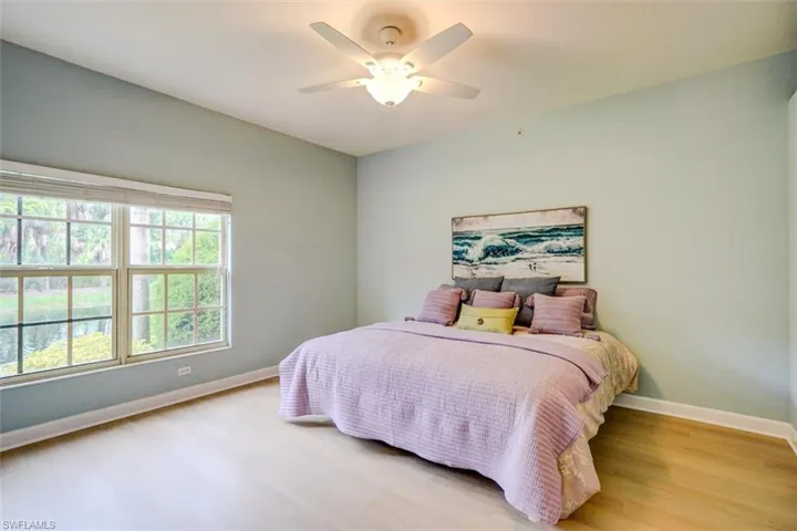 Bedroom with light hardwood / wood-style flooring and ceiling fan