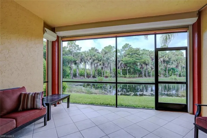 Sunroom featuring lofted ceiling and a water view