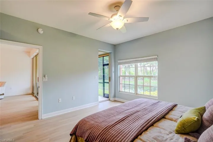 Bedroom with ceiling fan, light hardwood / wood-style flooring, and access to exterior