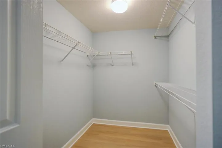 Spacious closet featuring hardwood / wood-style flooring