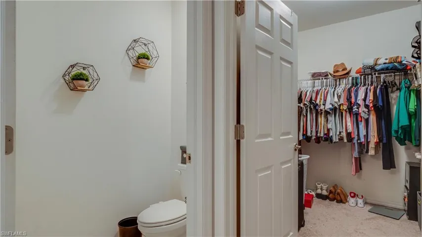 Bathroom with baseboards and a walk in closet
