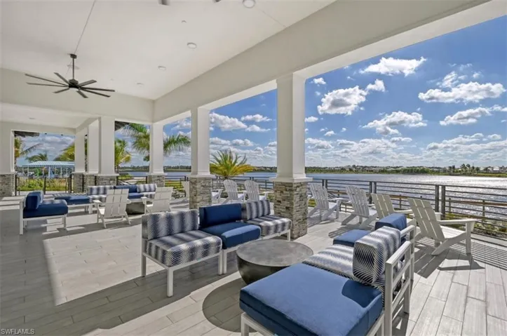 View of patio with an outdoor living space, a water view, and ceiling fan
