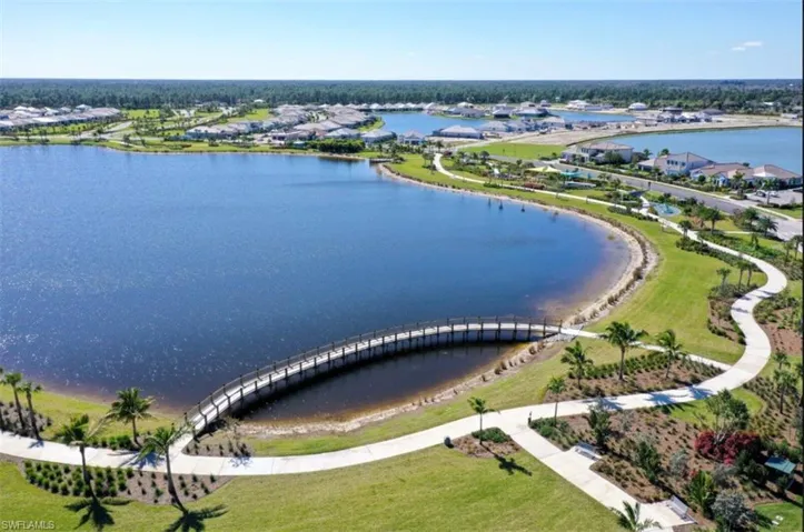 Birds eye view of property with a water view