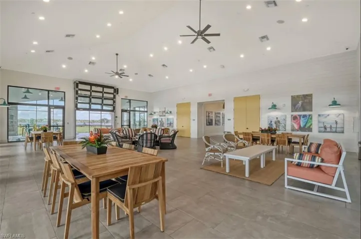 Dining room featuring ceiling fan and a towering ceiling