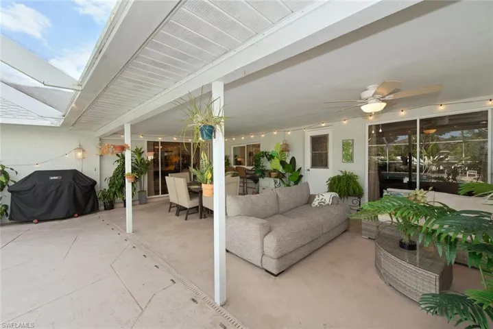 View of patio featuring a ceiling fan, grilling area, an outdoor hangout area, and outdoor dining space