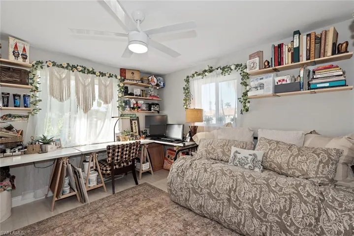 Office area with light wood-style flooring and ceiling fan