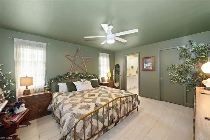 Bedroom with ceiling fan and ensuite bath