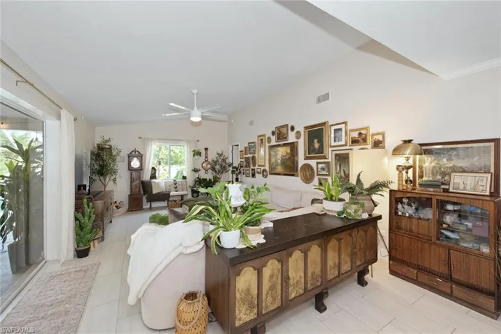 Living area with vaulted ceiling and ceiling fan