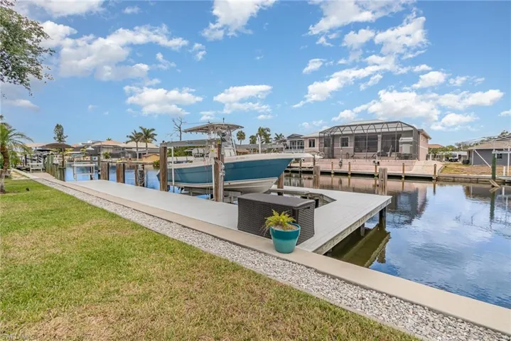 Seeing is believing! 75' Seawall on a wide canal! Heavy duty boat lift & wrap-a-round composite dock!