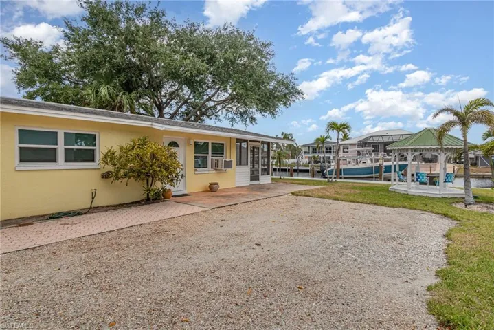 Surrounding the parking area is a gazebo and mature palm trees!