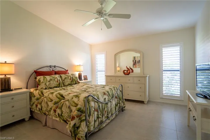 Primary Bedroom with a vaulted ceiling, and multiple windows